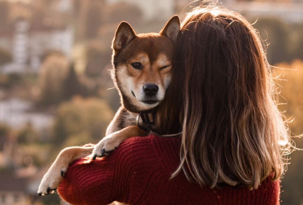 woman holding and hugging her dog